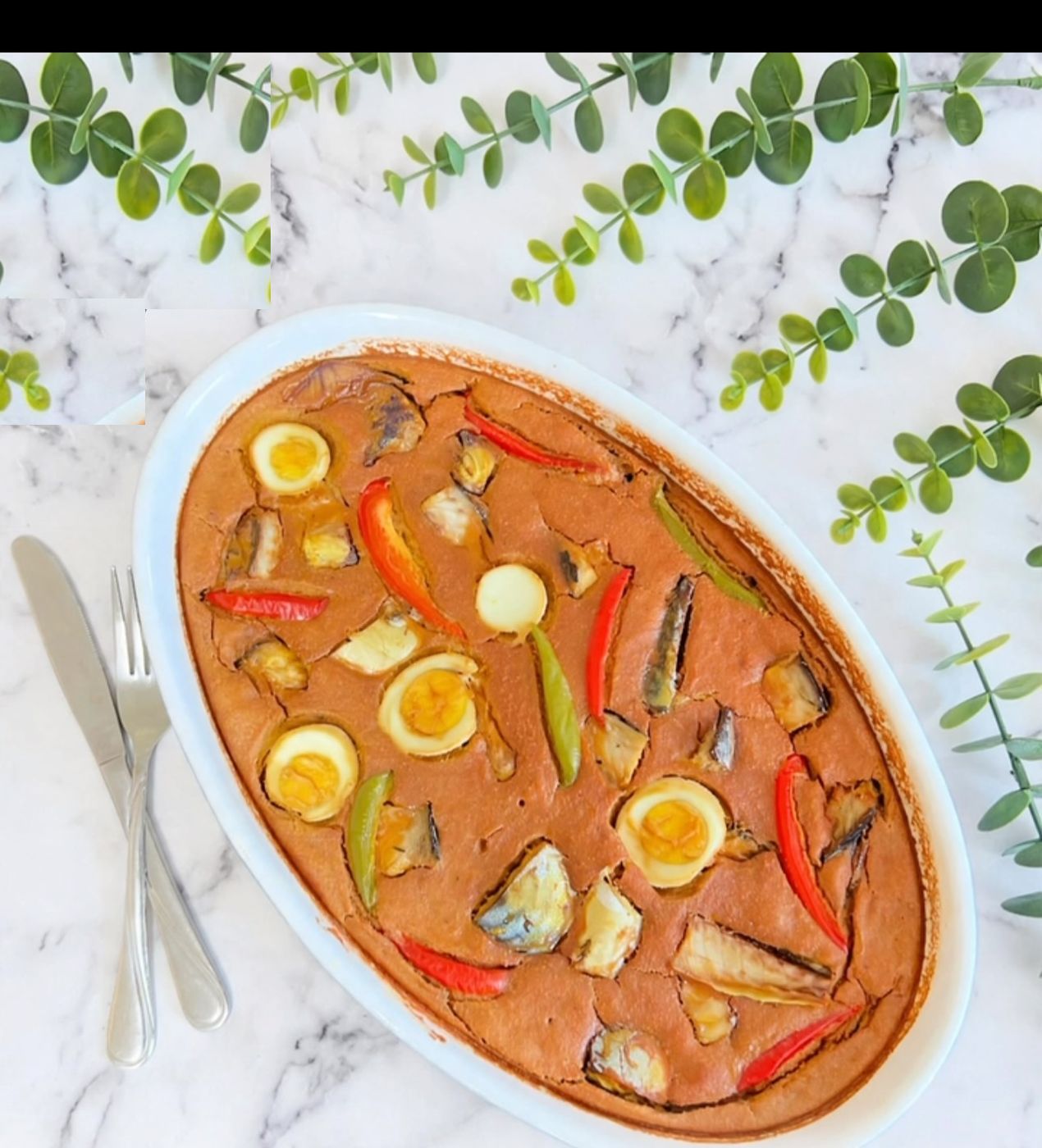 A rich African stew platter with eggs and peppers